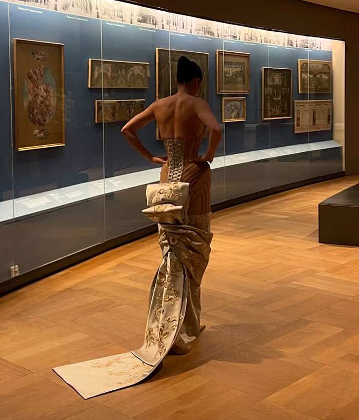 Fashion model in an intricate dress with detailed patterns, showcasing trends at Paris Fashion Week. Fashion model in an intricate dress with detailed patterns, showcasing trends at Paris Fashion Week.