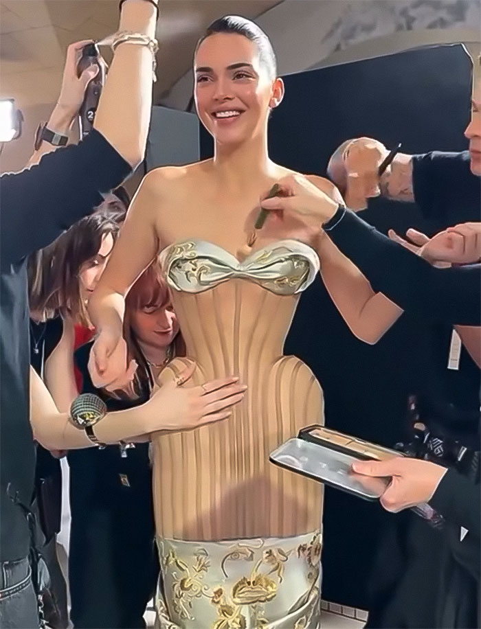 Kendall Jenner during Paris Fashion Week fitting, wearing an attention-grabbing dress, surrounded by stylists adjusting her outfit. Kendall Jenner during Paris Fashion Week fitting, wearing an attention-grabbing dress, surrounded by stylists adjusting her outfit.