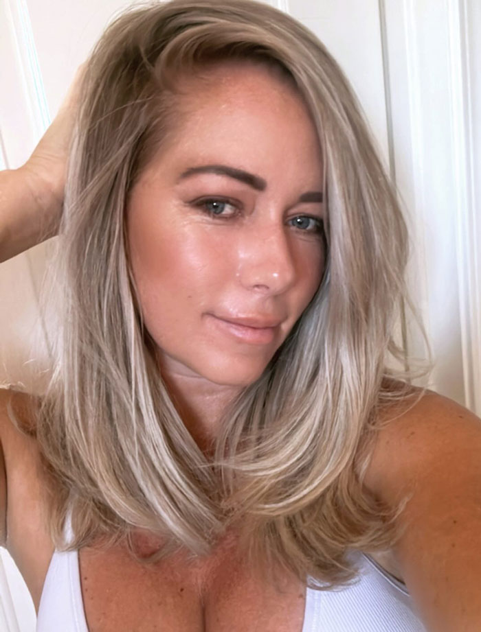 Blonde woman in a white top with confident expression, amid discussions on weight gain criticism. Blonde woman in a white top with confident expression, amid discussions on weight gain criticism.