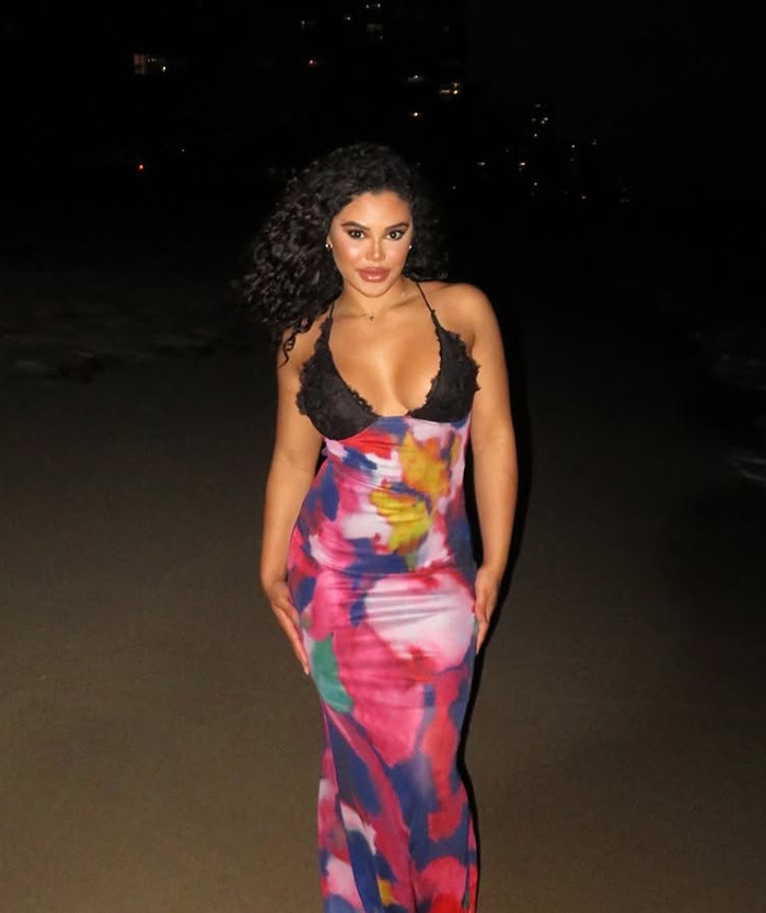 Kaya Odom in colorful dress on beach at night. Kaya Odom in colorful dress on beach at night.
