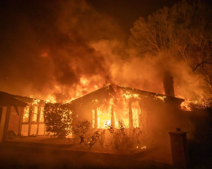 Burning house engulfed in flames illustrating Los Angeles wildfires tragedy. Burning house engulfed in flames illustrating Los Angeles wildfires tragedy.
