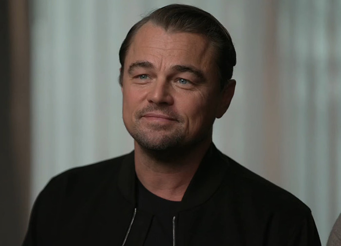 Leonardo DiCaprio in a black outfit indoors. Leonardo DiCaprio in a black outfit indoors.
