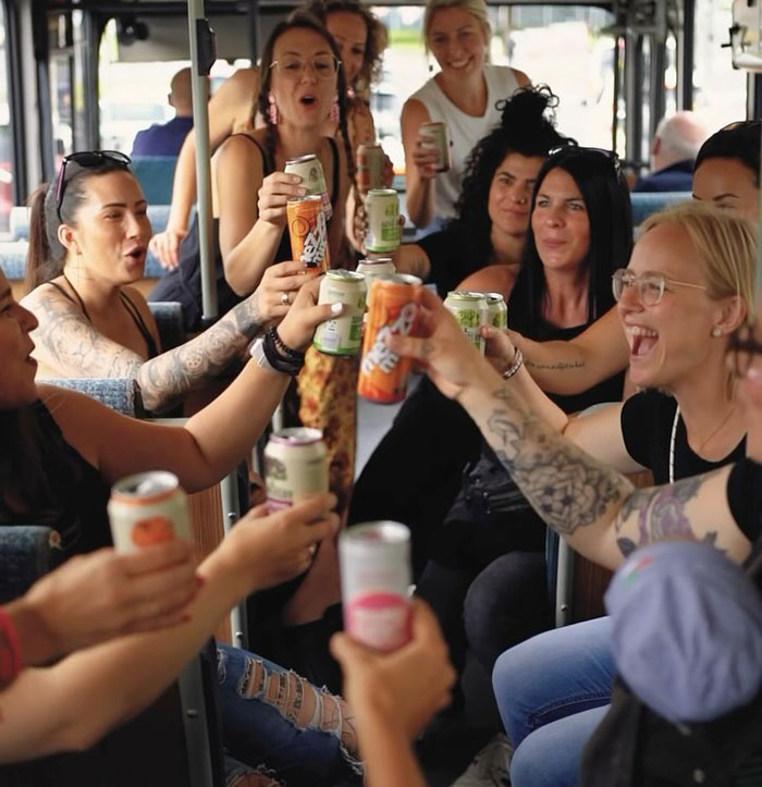 Moms celebrating with drinks on a party bus, redefining nightlife in post-baby era. Moms celebrating with drinks on a party bus, redefining nightlife in post-baby era.