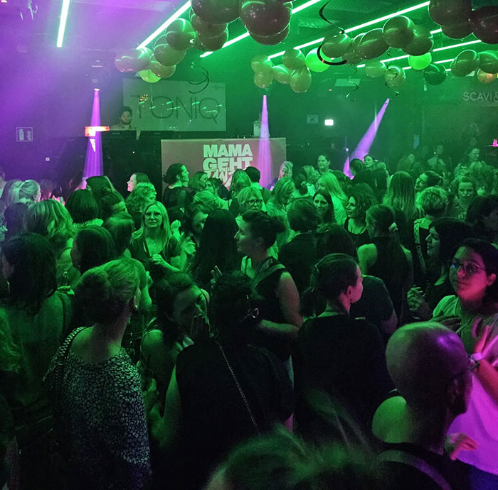 Moms redefining partying, vibrant nightclub scene with neon lights and a lively crowd on the dance floor. Moms redefining partying, vibrant nightclub scene with neon lights and a lively crowd on the dance floor.