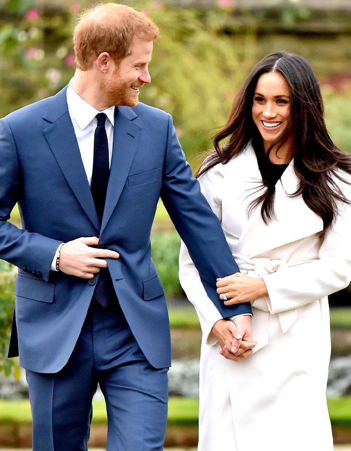 Meghan Markle smiling with her partner in formal attire, outside. Meghan Markle smiling with her partner in formal attire, outside.