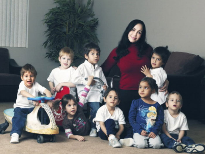 Nadya Suleman with her octuplets, sitting together in a living room setting. Nadya Suleman with her octuplets, sitting together in a living room setting.