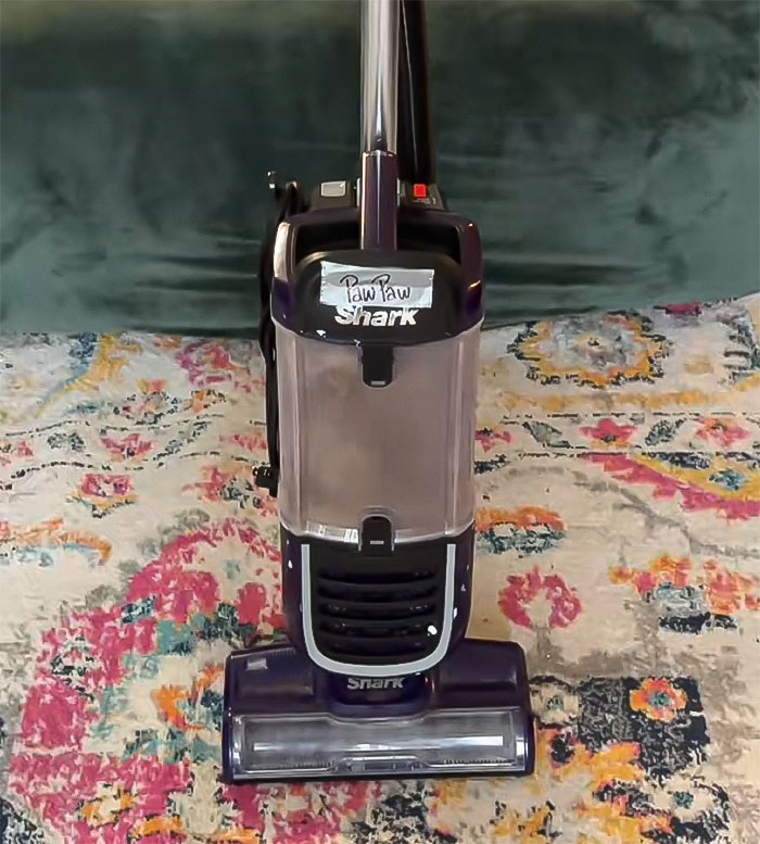Vacuum cleaner on colorful carpet, associated with mom cleaning sons' mouths from dirt. Vacuum cleaner on colorful carpet, associated with mom cleaning sons' mouths from dirt.