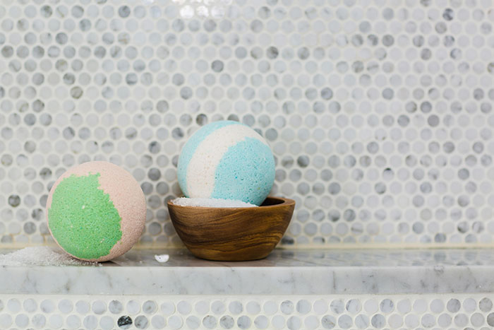 Colorful bath bombs on a marble shelf, reflecting a birthday gift theme. Colorful bath bombs on a marble shelf, reflecting a birthday gift theme.