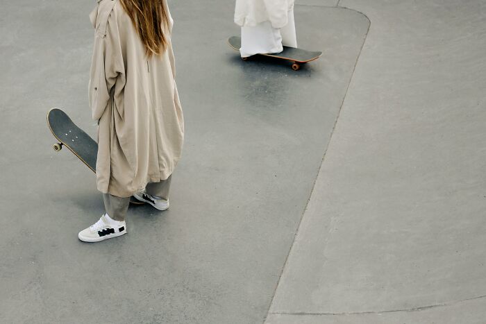 Teens skating at a park in 2000s-style baggy clothing, capturing a nostalgic memory.
