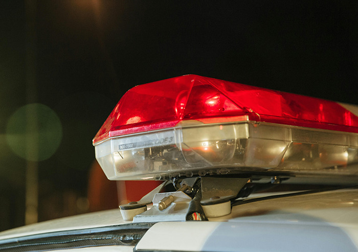 Police car with flashing lights at night, related to missing woman found after 52 years. Police car with flashing lights at night, related to missing woman found after 52 years.