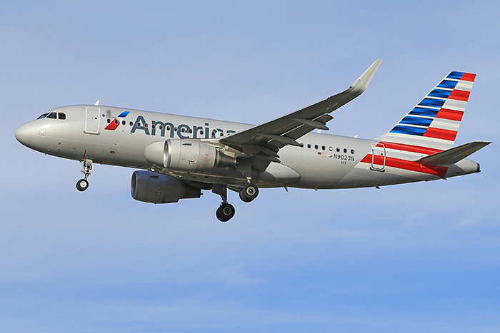 American Airlines plane in flight against a blue sky, referenced in DC plane crash story. American Airlines plane in flight against a blue sky, referenced in DC plane crash story.