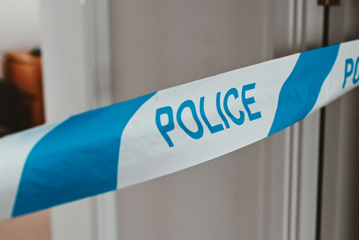 Police tape at a crime scene related to a family incident involving arranged marriage and malnourishment issues. Police tape at a crime scene related to a family incident involving arranged marriage and malnourishment issues.