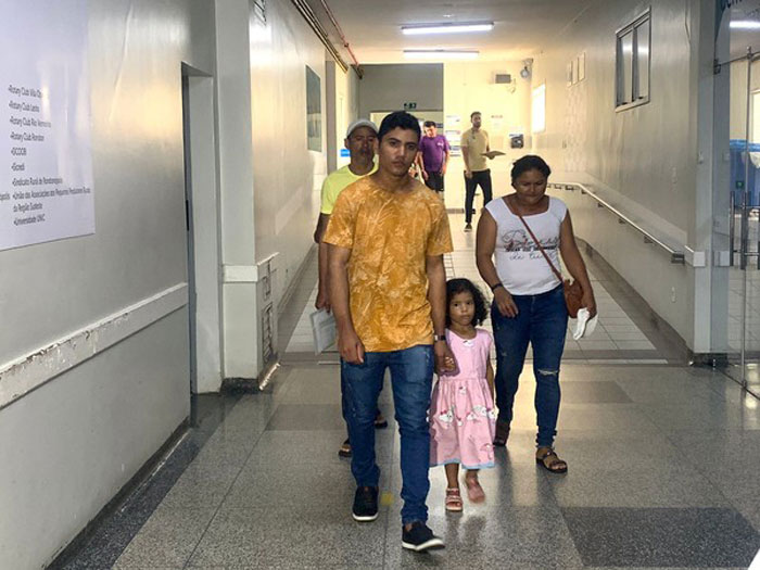 Family walking through hospital corridor amidst a devastating period concerning a pregnant woman on life support. Family walking through hospital corridor amidst a devastating period concerning a pregnant woman on life support.
