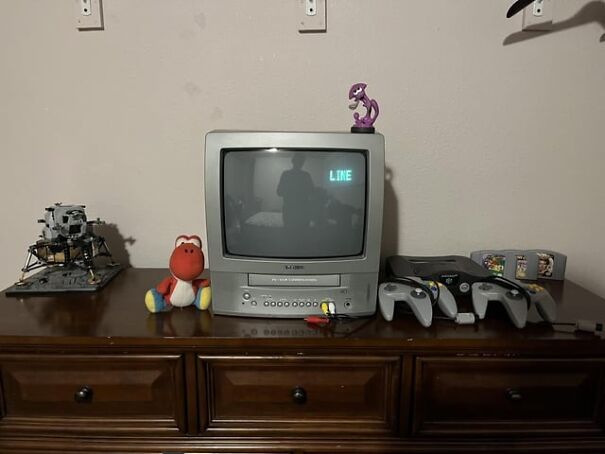 Retro finds featuring a vintage TV, gaming console, and nostalgic toys on a wooden dresser.