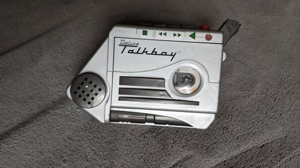 Retro cassette player Talkboy on a gray surface, evoking nostalgia.
