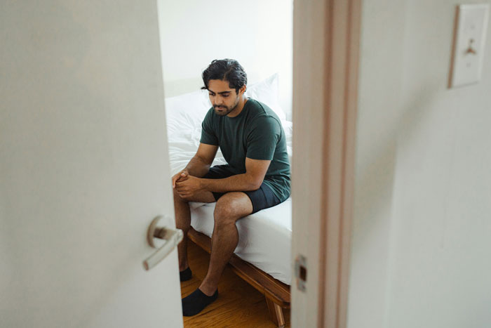Man sitting on a bed looking thoughtful, related to engagement and proposal. Man sitting on a bed looking thoughtful, related to engagement and proposal.