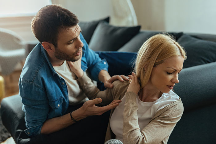 A couple having a serious discussion on a couch, with a focus on relationship dynamics and engagement topics. A couple having a serious discussion on a couch, with a focus on relationship dynamics and engagement topics.