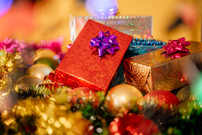 Christmas presents with colorful bows surrounded by festive decorations. Christmas presents with colorful bows surrounded by festive decorations.