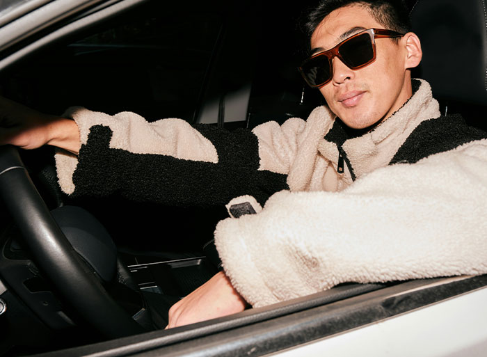Man in sunglasses and a cozy jacket confidently sitting in a car, embodying self-assuredness after a clever act of revenge. Man in sunglasses and a cozy jacket confidently sitting in a car, embodying self-assuredness after a clever act of revenge.
