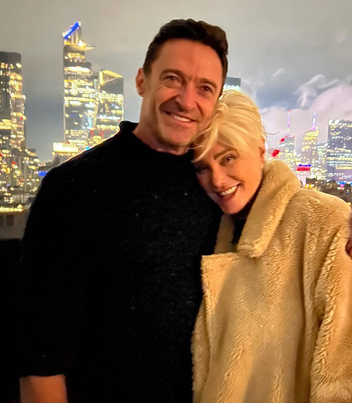 Deborra-Lee Furness and Hugh Jackman embraces against a city skyline at night. Deborra-Lee Furness and Hugh Jackman embraces against a city skyline at night.