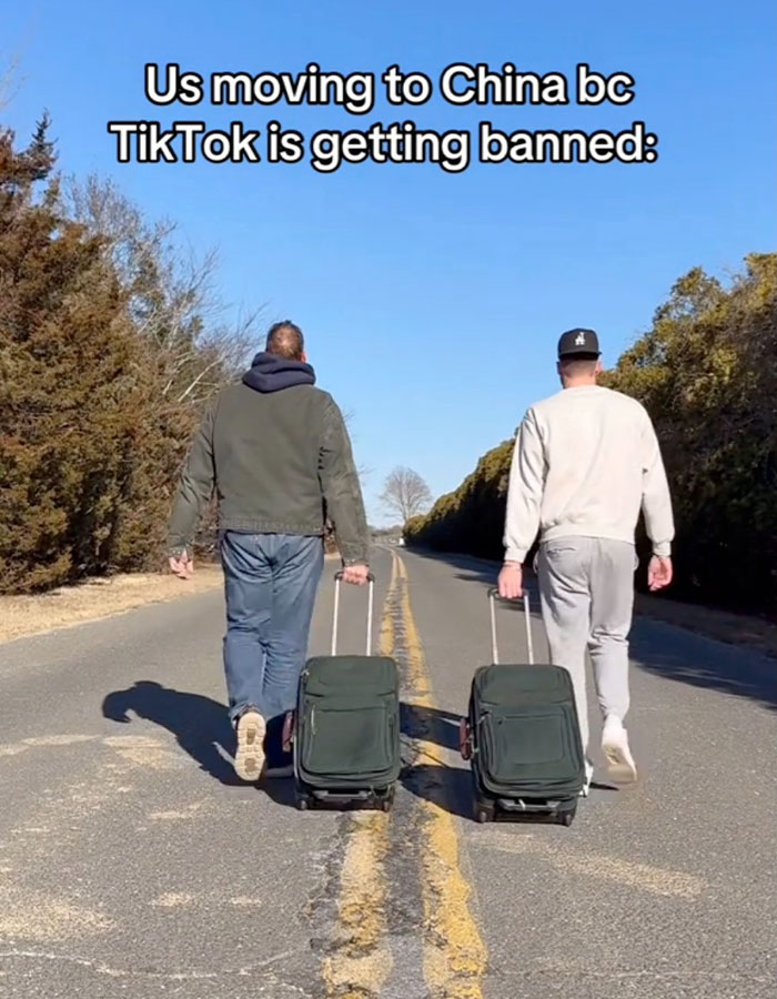 Two men walking down a road with luggage, reacting to TikTok ban, exploring life unplugged from the Matrix. Two men walking down a road with luggage, reacting to TikTok ban, exploring life unplugged from the Matrix.