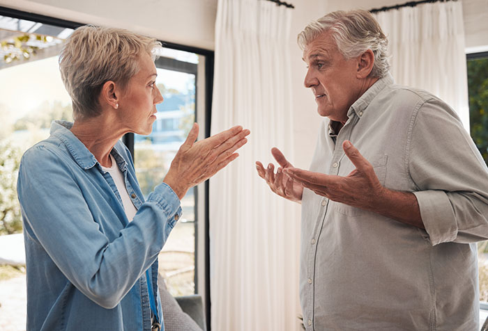 Elderly couple engaged in a tense discussion, reflecting neurodivergent relationship challenges. Elderly couple engaged in a tense discussion, reflecting neurodivergent relationship challenges.