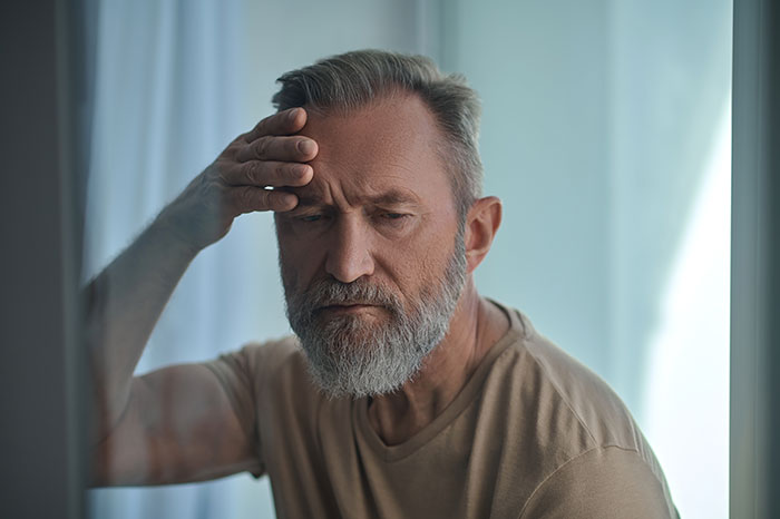Man with a thoughtful expression, hand on forehead, illustrating neurodivergent husband. Man with a thoughtful expression, hand on forehead, illustrating neurodivergent husband.