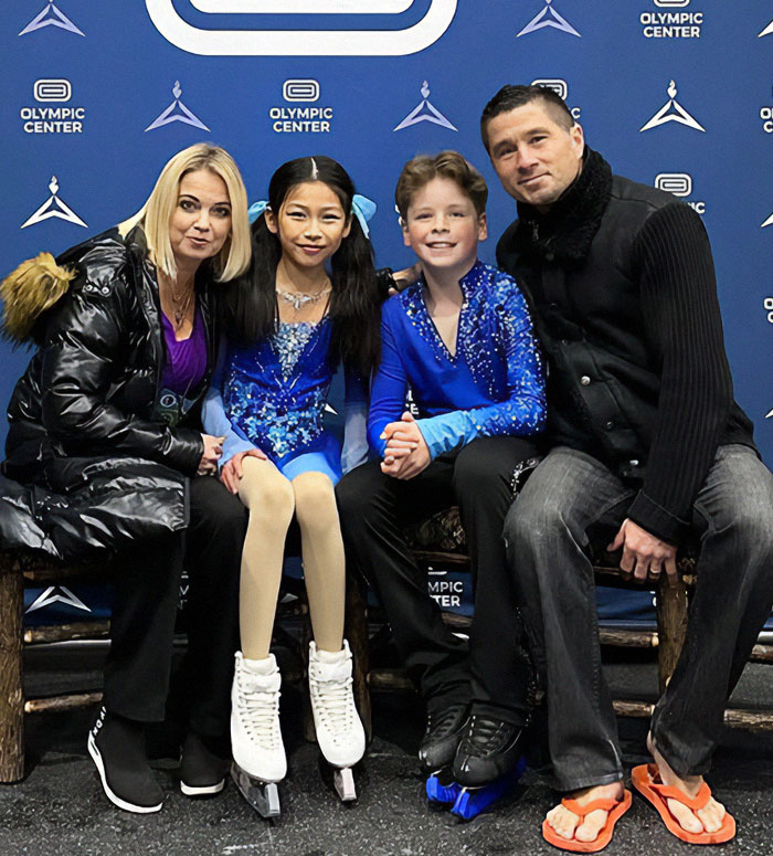 Adorable child ice skating duo with two adults at an Olympic Center event. Adorable child ice skating duo with two adults at an Olympic Center event.