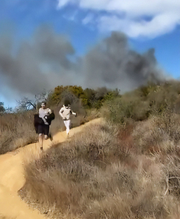 Young men captured running from smoke at La Palisades, sparking fire-related conspiracy theories. Young men captured running from smoke at La Palisades, sparking fire-related conspiracy theories.