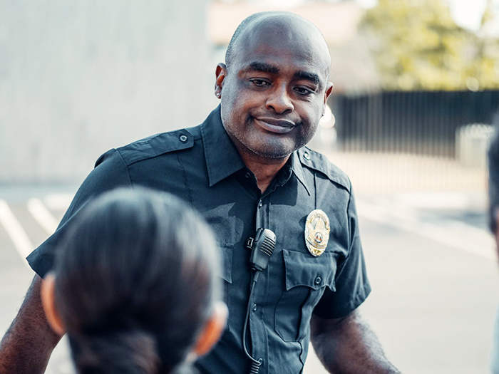 Officer talking to a woman outdoors, related to CPS call over toddler tantrums. Officer talking to a woman outdoors, related to CPS call over toddler tantrums.
