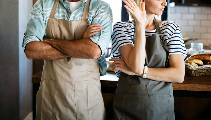Teen crosses arms in annoyance while woman gestures, connected to expensive skincare issue. Teen crosses arms in annoyance while woman gestures, connected to expensive skincare issue.