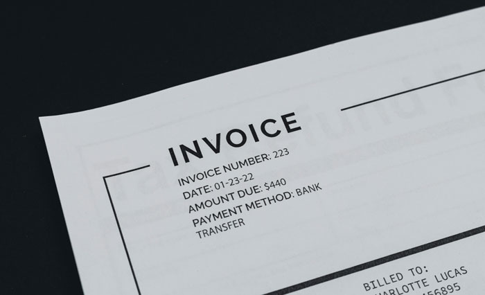 Invoice close-up showing details and payment method. Invoice close-up showing details and payment method.