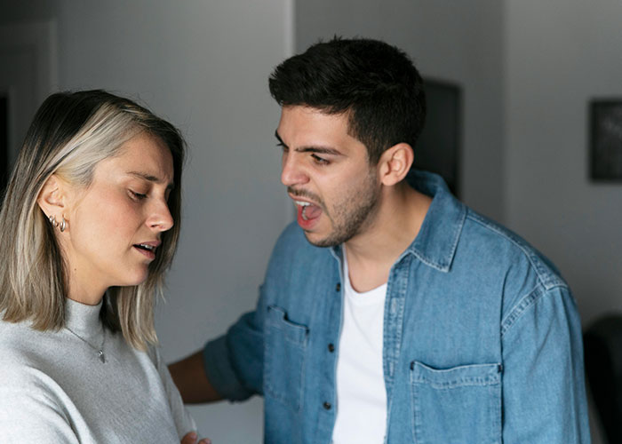 Man expressing anger towards a woman in a tense moment, highlighting relationship issues after sudden inheritance. Man expressing anger towards a woman in a tense moment, highlighting relationship issues after sudden inheritance.