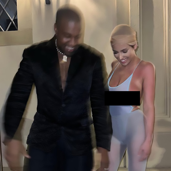 Two people standing together, dressed elegantly, with soft lighting in the background. Two people standing together, dressed elegantly, with soft lighting in the background.