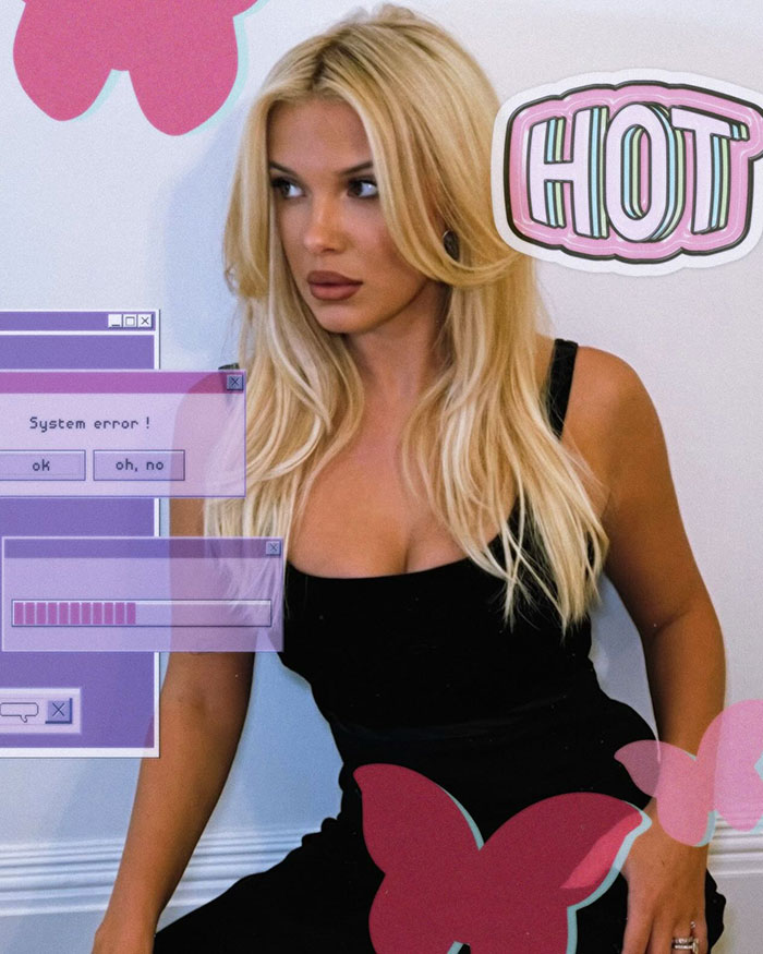 Blonde woman in a stylish black dress with graphic elements, showcasing a bold new look. Blonde woman in a stylish black dress with graphic elements, showcasing a bold new look.