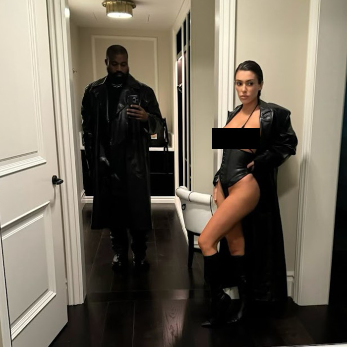 Kanye West and Bianca Censori in matching black outfits, standing in a hallway. Kanye West and Bianca Censori in matching black outfits, standing in a hallway.