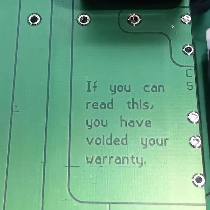 Circuit board message humorously indicating warranty voided, representing interesting images.