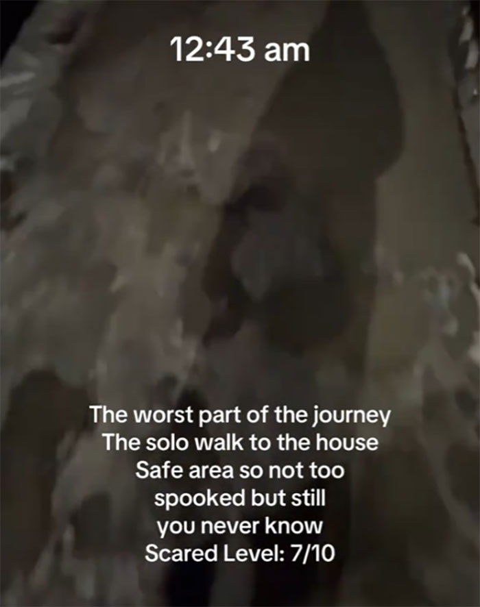 Woman walking alone in NYC at midnight, with text overlay rating fear level as 7/10. Woman walking alone in NYC at midnight, with text overlay rating fear level as 7/10.