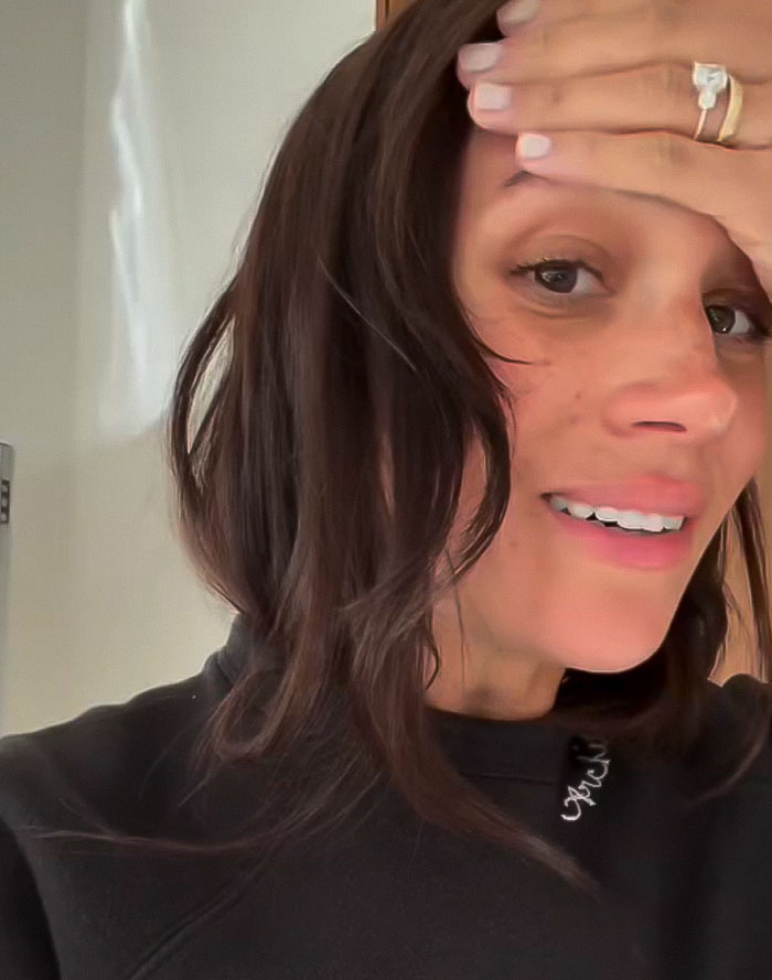 Woman in a casual setting, with hand on forehead, promoting her charity work. Woman in a casual setting, with hand on forehead, promoting her charity work.