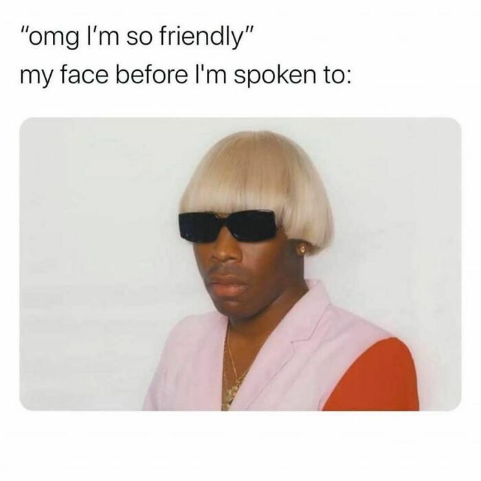 Man with blonde bowl cut wig and black sunglasses making a serious face, a humorous post for humor as a coping mechanism.