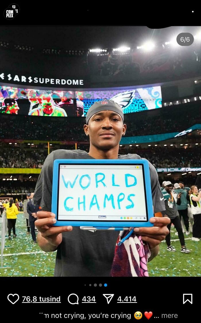 Young football player holding a sign with misspelled phrase at a crowded stadium, showcasing dumbest mistakes humor.
