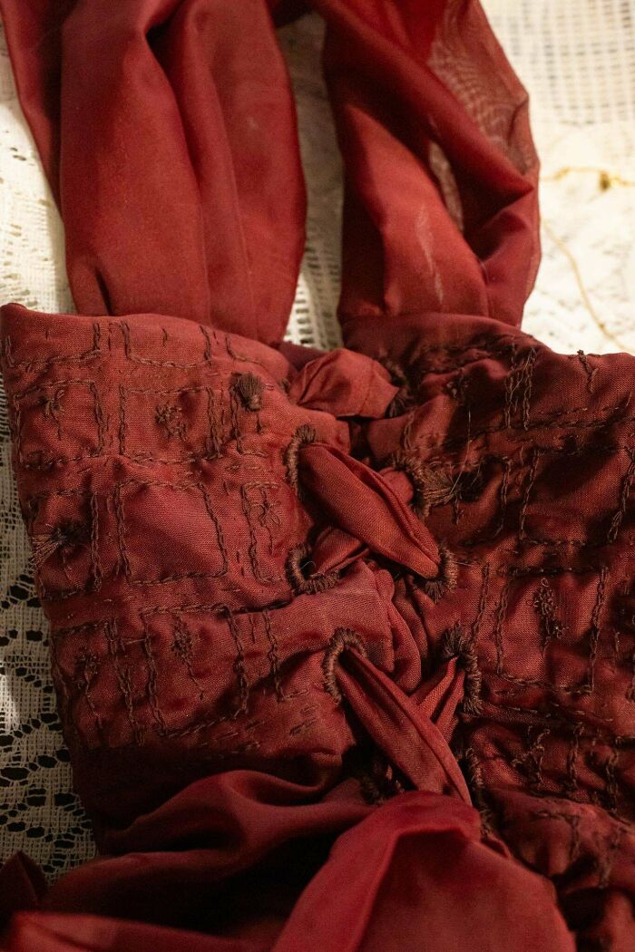 Red DIY project showcasing detailed fabric stitching on a textured background.