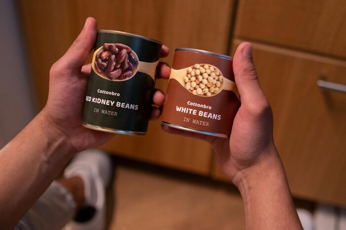 Hands holding canned red kidney and white beans, a brilliant life hack for quick meals.