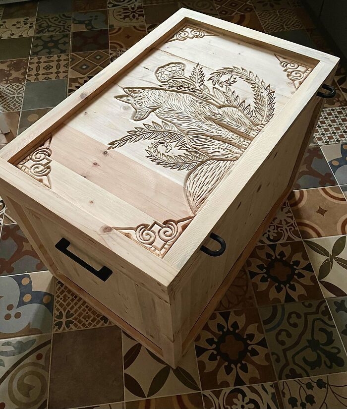 Wooden DIY project with intricate carved floral design on a box lid, showcasing craftsmanship on patterned tile flooring.