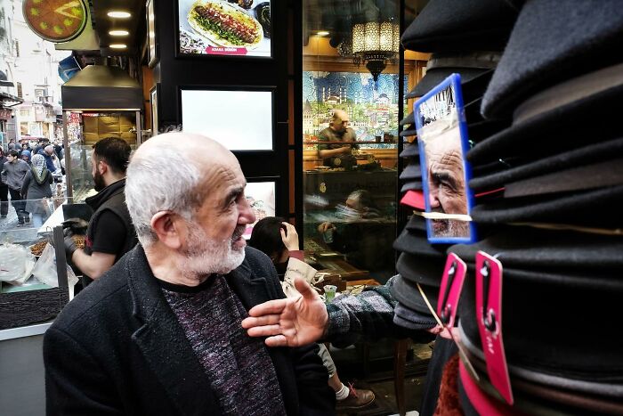Street scene with a man gesturing, captured in a unique way, showing how Gökhan Arer sees the streets differently.