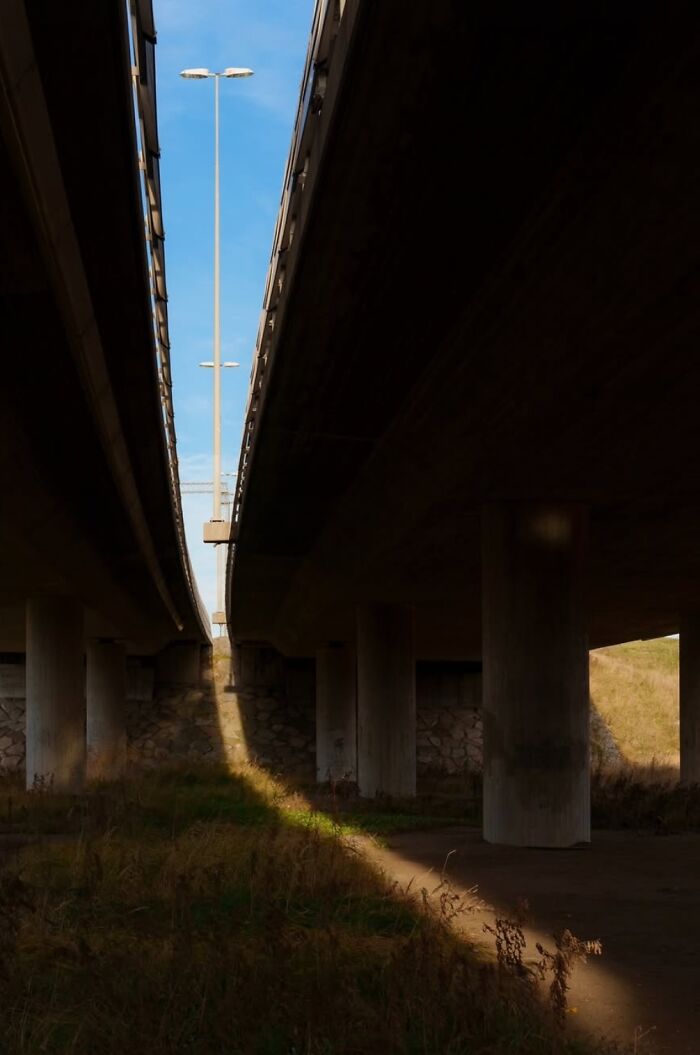 Street photography by André capturing overpass shadows in Oslo.