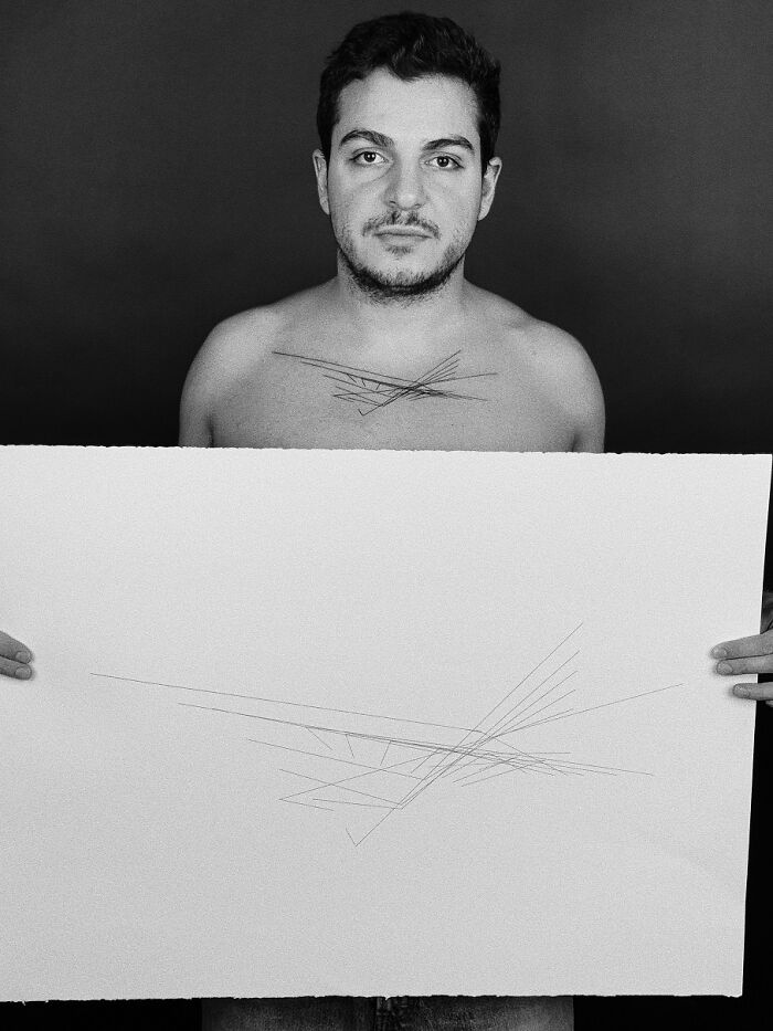 Man displaying tattoo inspired by unique brain activity pattern on chest, holding matching abstract artwork. Man displaying tattoo inspired by unique brain activity pattern on chest, holding matching abstract artwork.