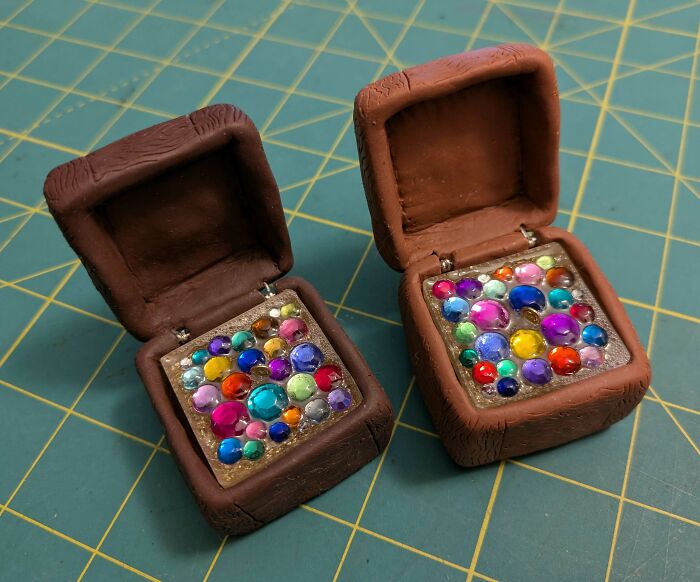 DIY projects: handmade boxes with colorful gems on a patterned surface.