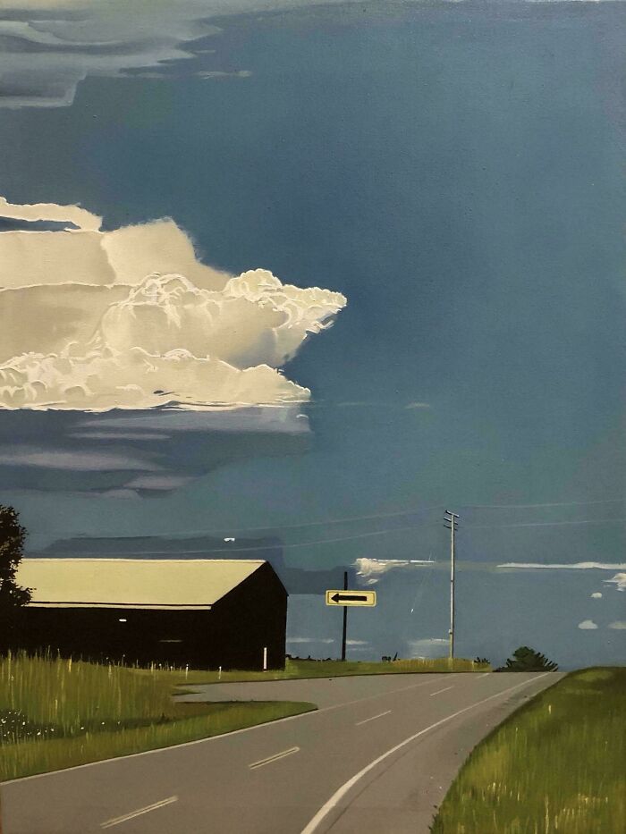 "DIY project inspiration: Serene rural landscape with barn, road, and dramatic clouds enhancing natural beauty."