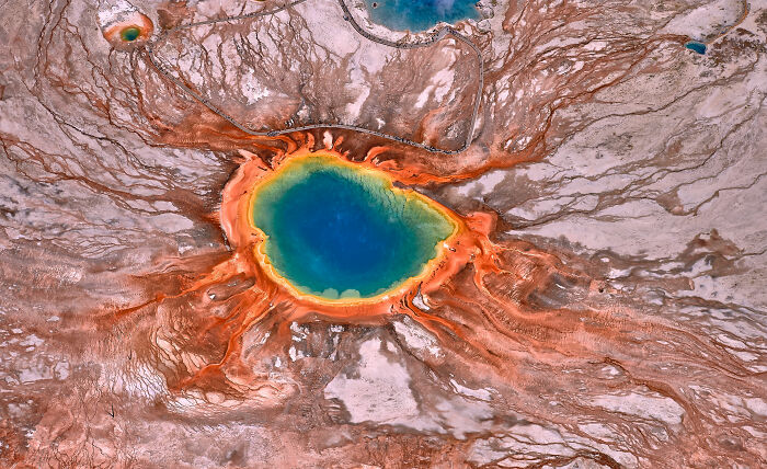 Aerial view of colorful geothermal spring, showcasing stunning natural patterns and vibrant hues for World Nature Photographer.